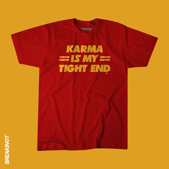 A red and yellow shirt with "Karma is my tight end."